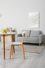 Fruit basket on dining table in room interior