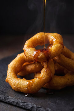 Picarones, a traditional Peruvian dessert made from pumpkin and sweet potato with chancaca honey, delicious food, Peru