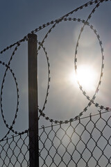 Razor Wire Fence and Clear Bright Sky, Concepts of Border Control, Human Rights, Political Freedom,...