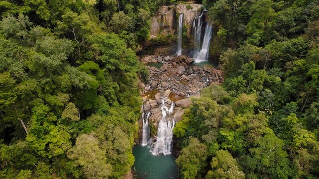 Nauyaca Waterfalls surrounded by dense tropical rainforest in Costa Rica, aerial view