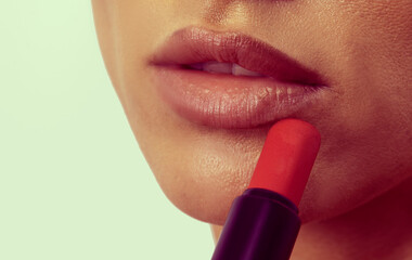 woman applying lip gloss on her lips. Sensual woman. Sensual. Lips. Background. Beauty. Model. Photo. People