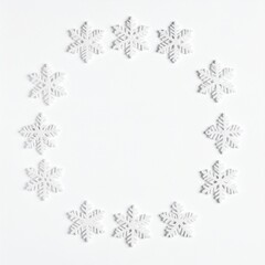 Snowflake circle frame on white background, winter holiday concept.