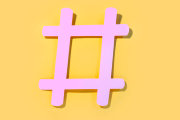 Hashtag made of paper on color background