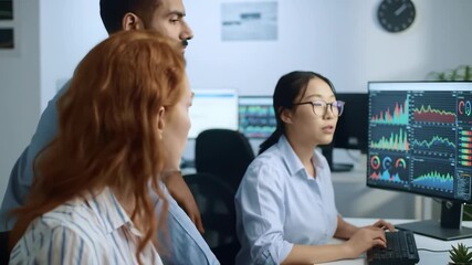 Professionals collaborating closely while viewing data visualization on computer monitors - Powered by Adobe