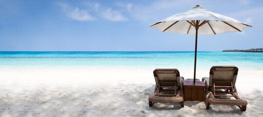 White parasol with sun chairs on turquoise sea beach, perfect summer vacation on Maldives island. Long banner with copy space