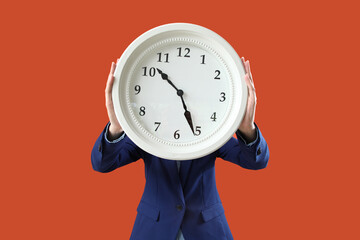 Woman with clock on orange background
