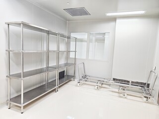 Clean room with metal shelving and carts.