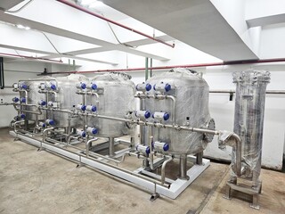 Industrial water filtration system with tanks and pipes.