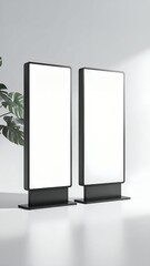 Two sleek, modern digital signage displays with blank white screens, perfect for advertising mockups in a minimalist setting.