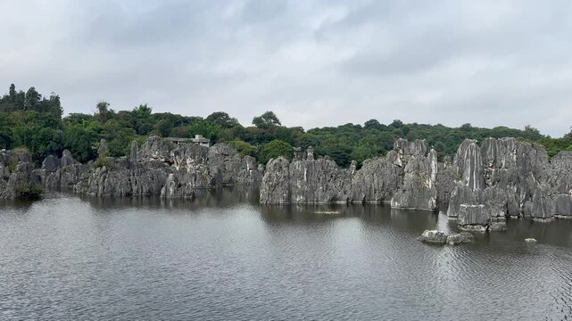 Scenic view inside Stone Forest with lake. Stone forest is a popular tourist destination.