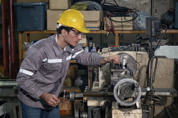 Skilled engineers operate industrial lathe in busy factory workshop, focus and safety gear highlight precision metal work and human teamwork under warm light for production success