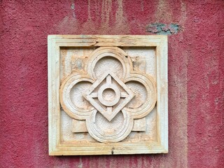 geometric stone relief on red wall  © Gepeemwe