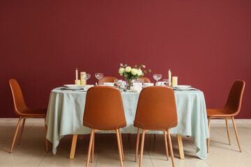 Beautiful table setting for Nobel prize day with flowers and candles in dining room