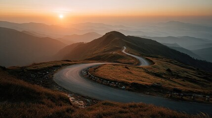 Winding mountain road curving through golden hills at sunrise with layered misty landscape and warm atmospheric light