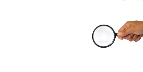 Close-up holding a magnifying glass on a white background.