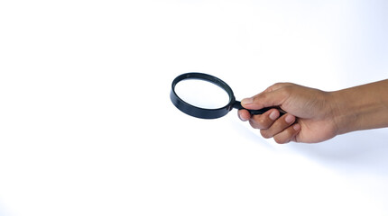 Close-up holding a magnifying glass on a white background.