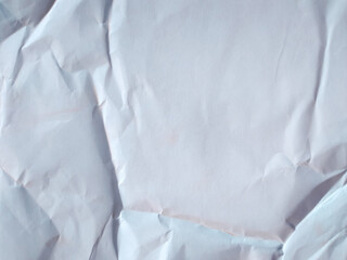 White crumpled paper texture background. Wrinkled and folded white paper sheet surface for overlay or grunge texture.