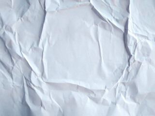 White crumpled paper texture background. Wrinkled and folded white paper sheet surface for overlay or grunge texture.