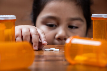 A close-up portrait shot showing the face of a young girl (preschooler) with innocence and...