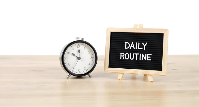 Clock and Daily Routine Sign on Wooden Table - Time Management and Productivity Concept.