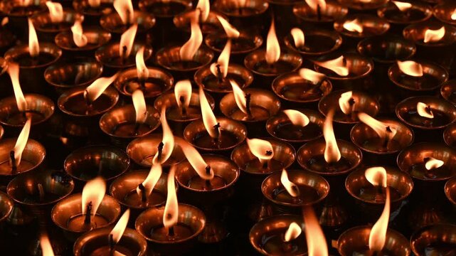 Light candles in Swayambhunath temple, Nepal. The faithful also light candles as a sign of gratitude to God for answered prayers.