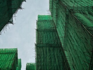 Bamboo scaffolding with building under construction with scaffolding, Hongkong Construction Safety, bamboo sticks
