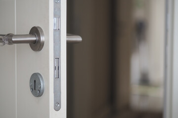 Naklejka premium Door with modern handle and lock in a light space