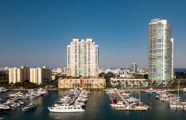 Obraz premium Miami Beach marina aerial drone view with skyline. Miami from above. Drone view of Miamis famous landmarks. South Pointe beach with skyscrapers. Miami city panorama. Skyline of Miami Beach.