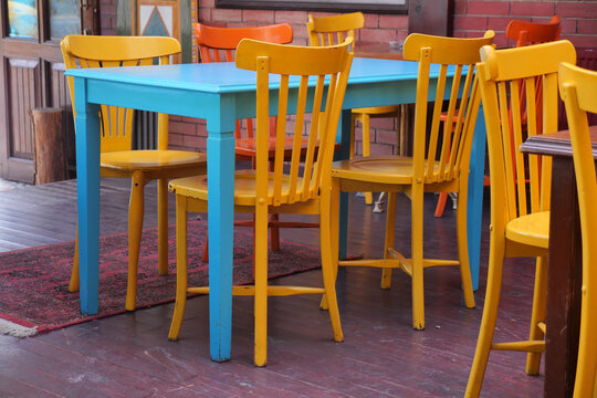 Colorful chairs and table in a vibrant cafe setting