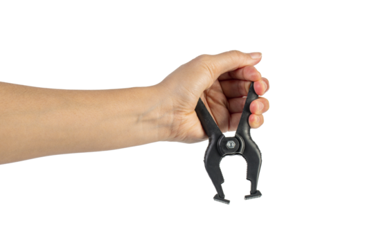 A studio shot of a black plastic spring clamp in hand isolated on a transparent background