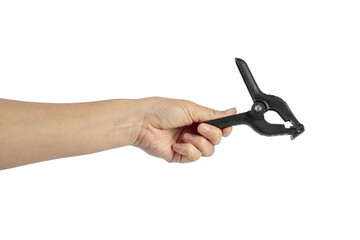 A studio shot of a black plastic spring clamp in hand isolated on a transparent background
