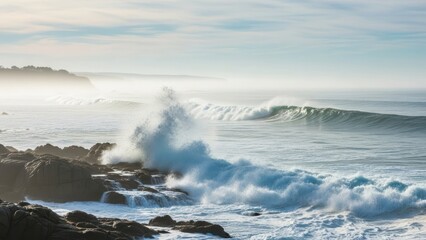 Dramatic ocean waves crashing against rugged rocks on a misty coastline landscape