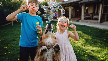 Playful children blowing bubbles with joyful dog trying to catch them in sunny backyard, creating happy and lively family moment outdoors