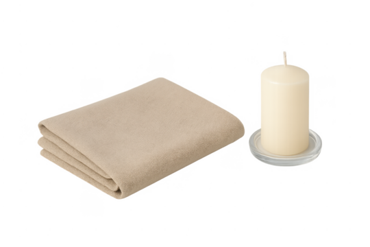 Folded beige towel and candle for spa wellness