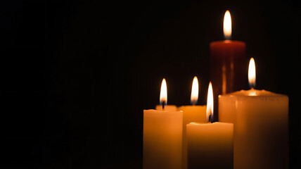 Illuminated candles glowing softly in a dark and serene environment