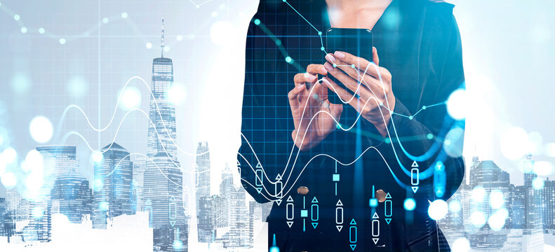 Woman in business attire using smartphone, abstract financial charts over modern city background, creative concept of digital economy and analytics - Powered by Adobe