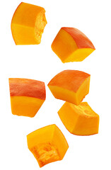 photograph showcasing several large, bright orange chunks of raw pumpkin or winter squash, ready for cooking and preparation, isolated on black.