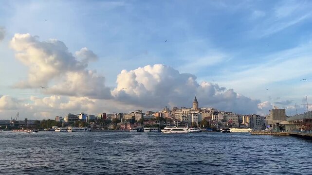 Karakoy Coastline, Galata Bridge and behind Galata Tower from Eminonu Port in Istanbul, Turkey. (4K Video)