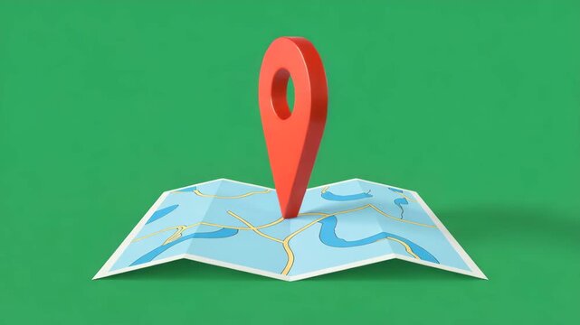 Red map pin inserted into a folded paper map location marker