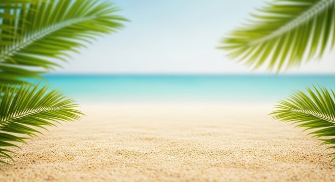 Two palm leaves on a sandy beach with a blurred ocean background.