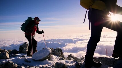Inspiring mountain climb adventure with a group of hikers conquering snow peaks and clouds