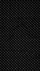 Dark, textured surface showing a repeating pattern of slightly raised diamond shapes