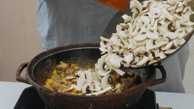 In a deep cast-iron skillet, chicken is fried in vegetable oil with teriyaki sauce