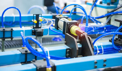 pneumatic hose fittings that connect to air hoses are installed on pneumatic equipment on a production line