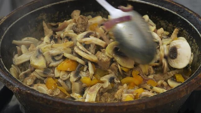Chicken in teriyaki sauce and champignons are fried in vegetable