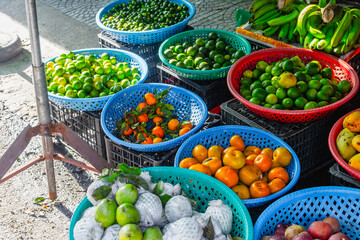 Vibrant fruit market display with citrus and tropical fruits in colorful baskets