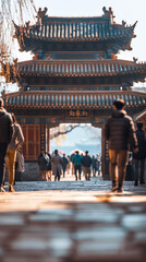 People walking through traditional Chinese temple gate