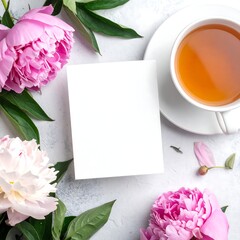 Overhead shot of flowers and tea with white blank card