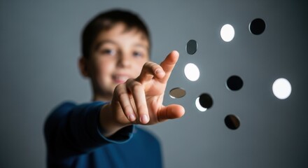 Young boy points at floating circles, creating an optical illusion.