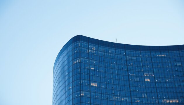 Modern Architectural Design of a Curved Glass Building Against a Clear Sky